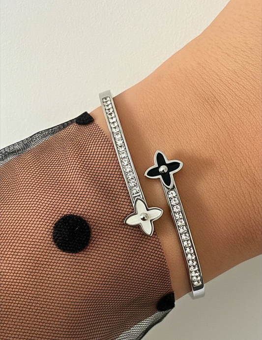 WRIST WEARNG SILVER BANGLE ON NEUTRAL BACKGROUND