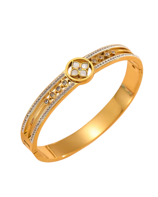 Gold bracelet with diamond accents on a white background