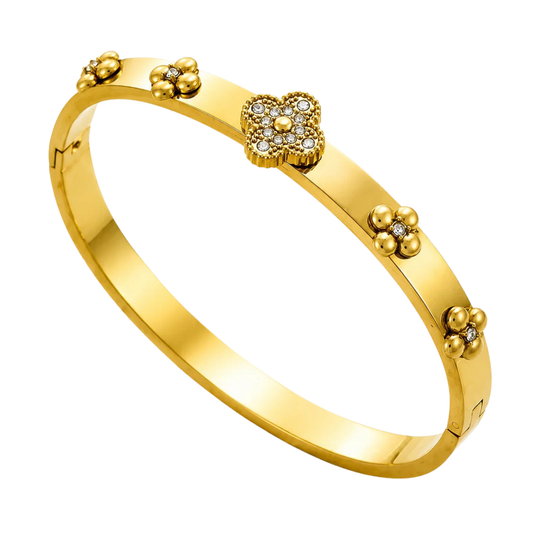 Gold bracelet with floral designs on a white background