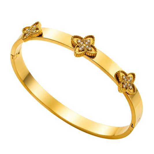 Gold bracelet with clover-shaped charms on a white background