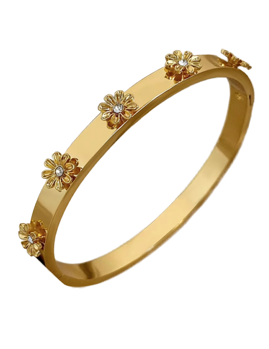 Gold bracelet with floral designs on a white background